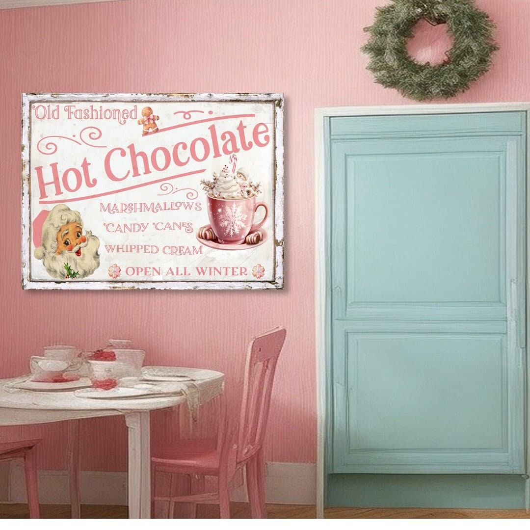 pink and white canvas sign that says Old Fashioned Hot Chocolate. Features a pink retro santa, a gingerbread man and a cup of hot chocolate