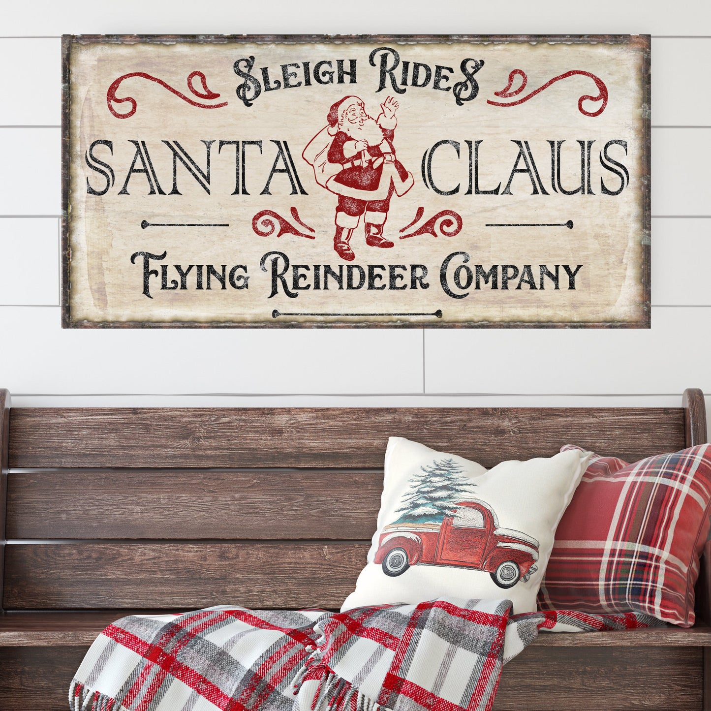 May include: A vintage-style sign with the text 'Sleigh Rides Santa Claus Flying Reindeer Company' in red and black lettering. The sign has a distressed white background and is decorated with ornate flourishes. A cartoon image of Santa Claus is in the center of the sign.