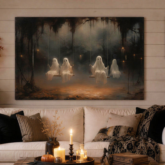 A large rectangular wall art print depicting three ghostly figures in a dark haunted forest hangs above a white sofa in a styled living room. The room includes a rustic wooden coffee table, black accent pillows, a hanging 'Home Sweet Haunted Home' sign, pumpkins, spiderwebs, and a fireplace.
