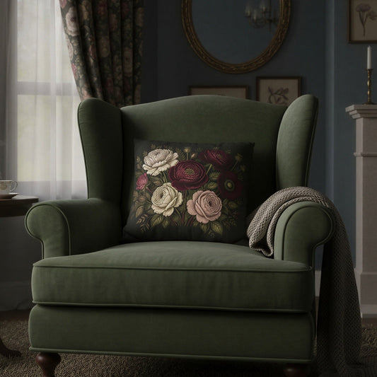 An olive green wingback armchair in a styled living room, featuring a dark floral accent pillow and a draped throw blanket, set against a blue wall with a fireplace and curtains.