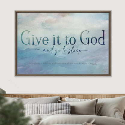 Framed artwork with 'Give it to God and go to sleep' text above a bed.