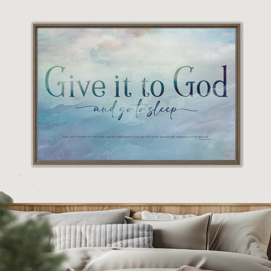 Framed artwork with 'Give it to God and go to sleep' text above a bed.