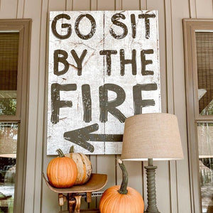 canvas art that looks like an old wooden sign  - says Go sit by the fire